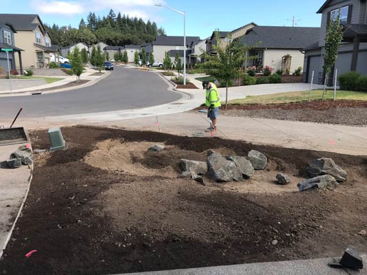 Landscape preparation with boulders and soil grading