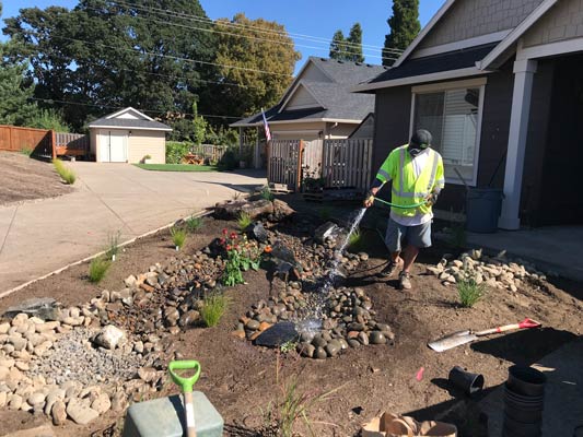 Installing dry creek bed landscaping feature