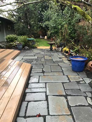 Stone patio with rustic pavers and surrounding greenery